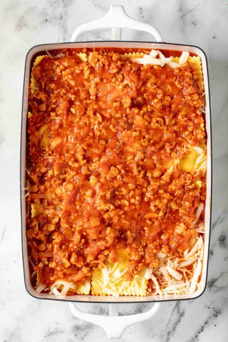 Easy Ravioli Lasagna Ravioli Lasagna in a white baking dish.