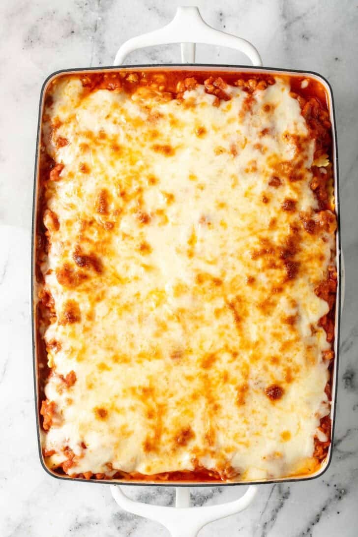 Easy Ravioli Lasagna Recipe Easy Ravioli Lasagna in a white baking dish.
