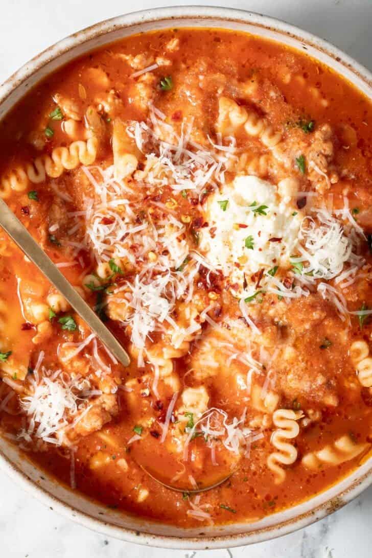 Easy Lasagna Soup Lasagna Soup in a bowl with a spoon.