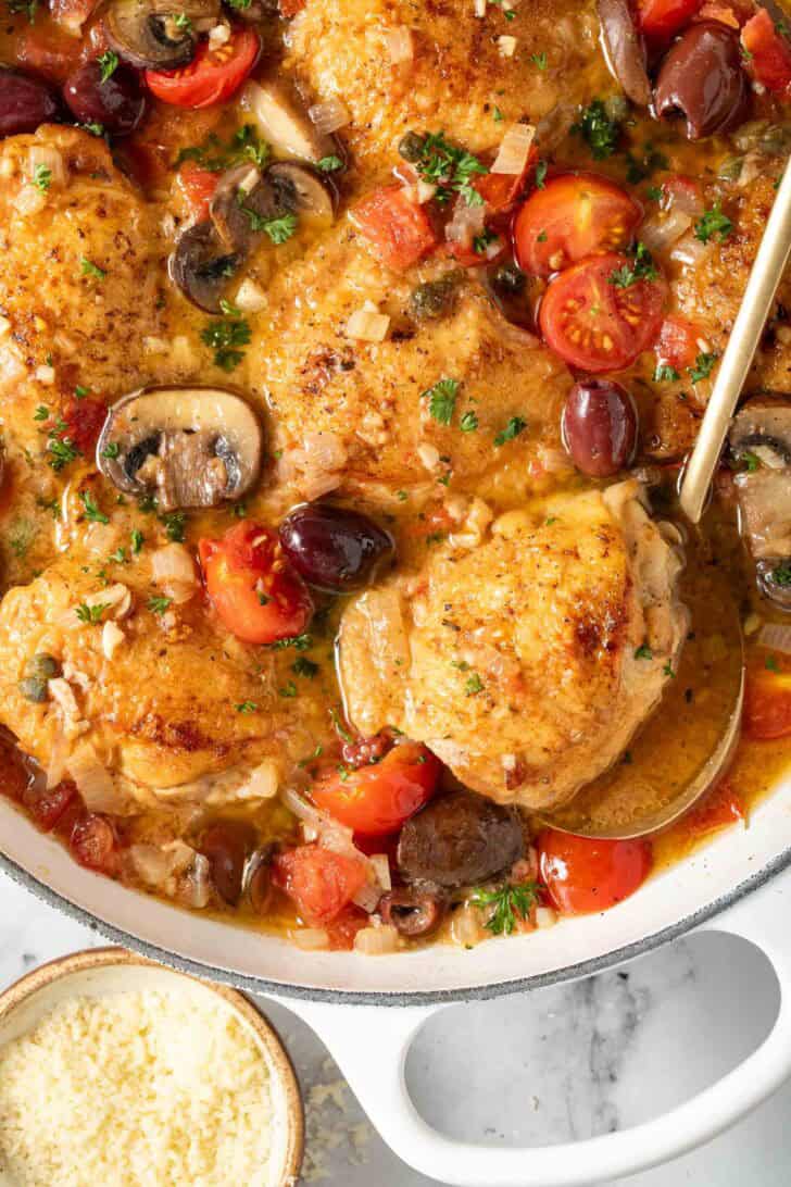 Italian Chicken Thighs Italian Chicken thigh in a Dutch oven.