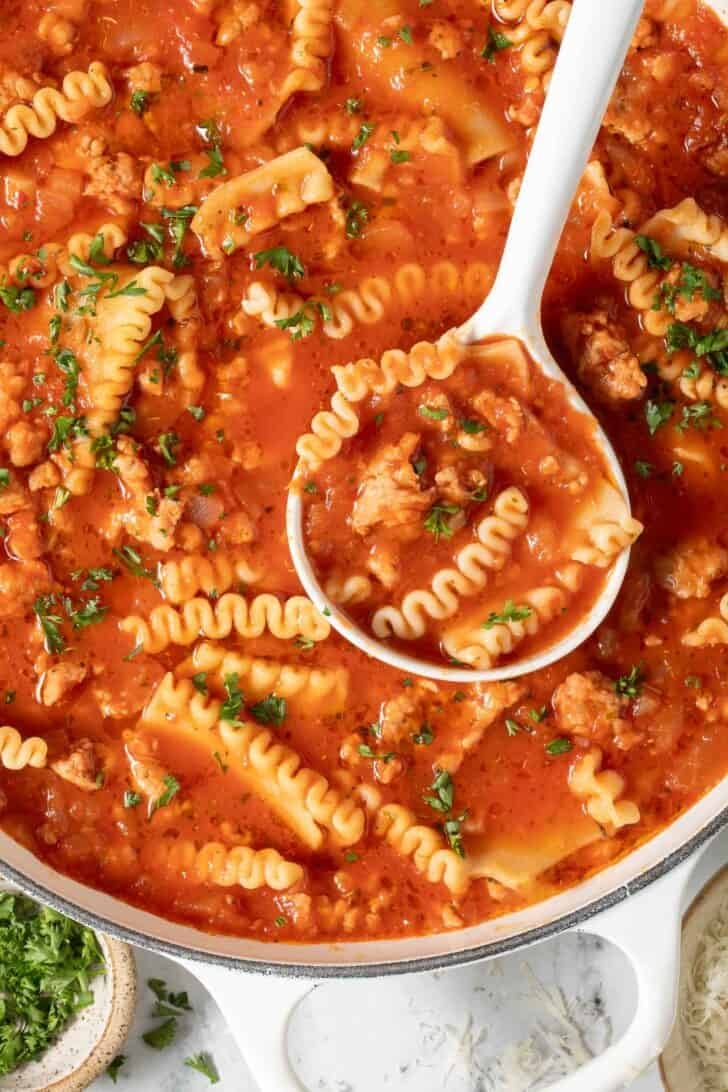 Lasagna Soup Recipe Lasagna Soup in a white pot with a white ladle.