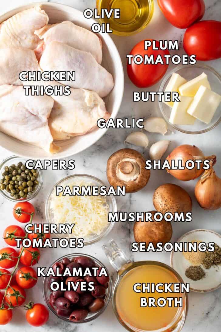 Mediterranean Chicken Recipe Chicken thighs in a bowl, next to mushrooms and tomatoes.