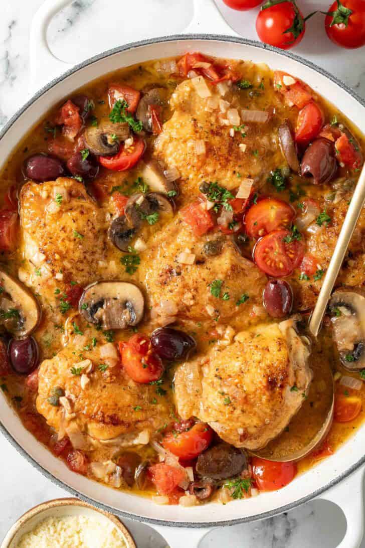 Mediterranean Chicken. Mediterranean Chicken in a white Dutch oven.