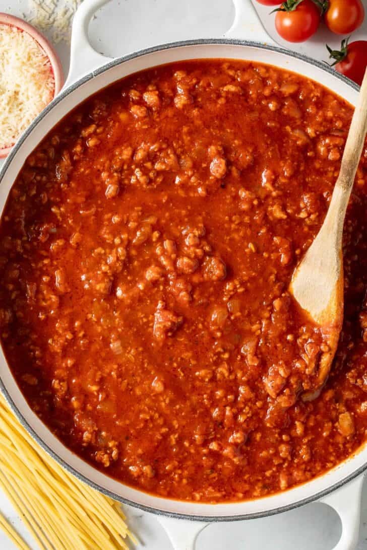 Homemade Spaghetti Sauce Seasoning Spaghetti sauce with meat in a white Dutch oven.