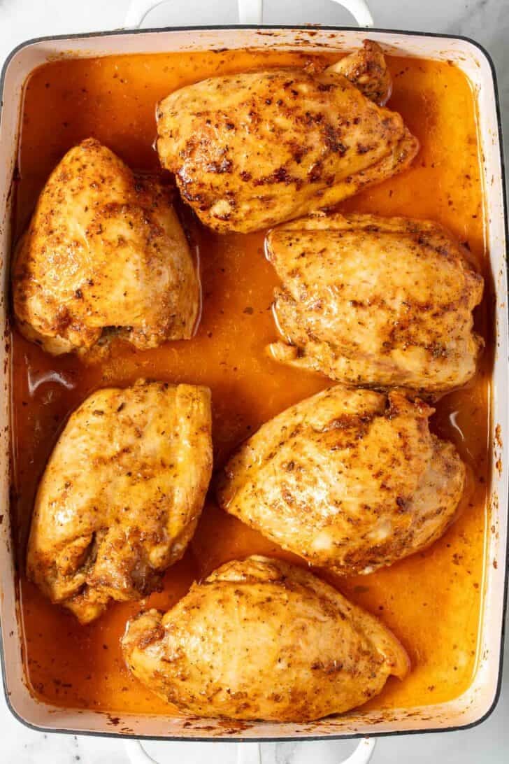 Baked Boneless Skinless Chicken Thighs Baked Boneless Skinless Chicken Thighs in a white baking dish.