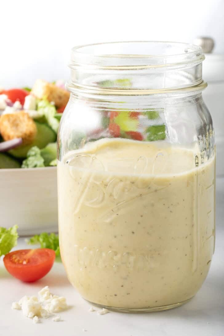 Greek Feta Dressing Greek Feta Dressing in a clear glass mason jar.