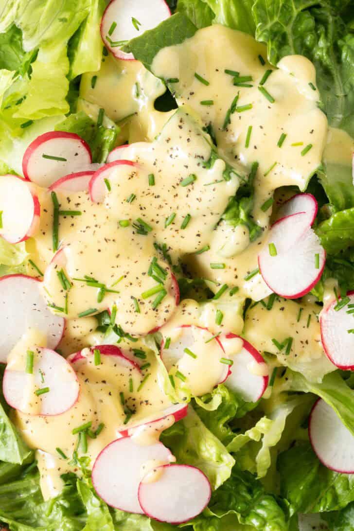Dijon Vinaigrette Dressing Recipe A green salad tossed with Dijon vinaigrette salad dressing.