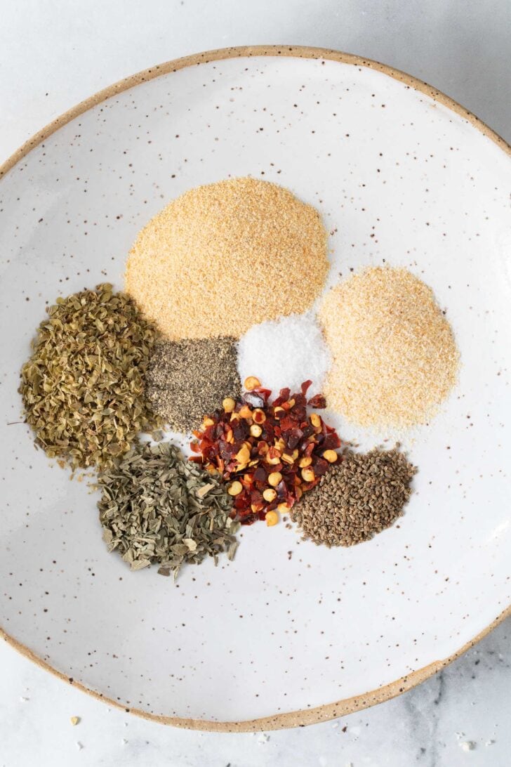 Dry Italian Salad Dressing Mix Dry Italian Salad Dressing Mix seasonings in a small white dish.