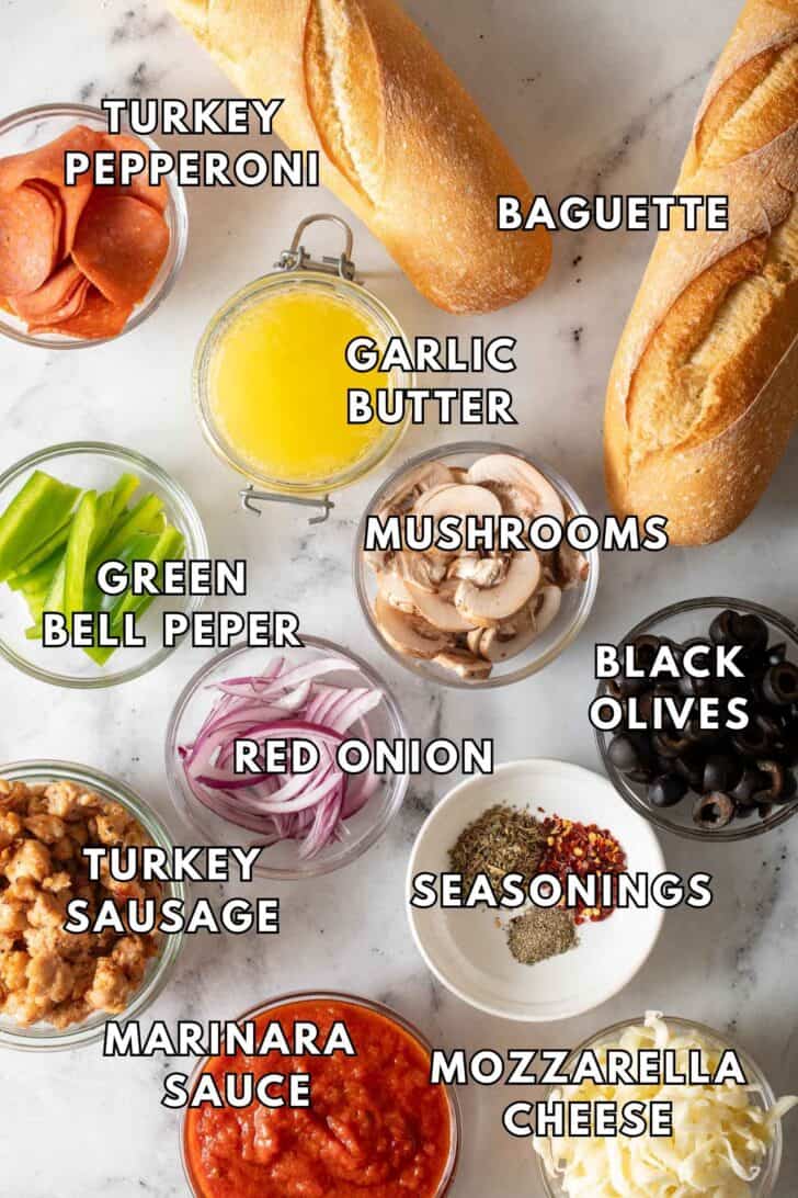 French Bread Pizza Recipe Clear glass bowls filled with cooked turkey sausage, turkey pepperoni, sliced onions, mushrooms and bell peppers for French bread pizza.