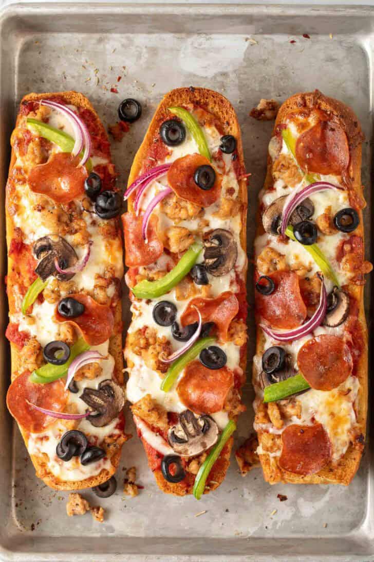 Garlic Bread Pizza Three French Bread Pizzas on a baking sheet.