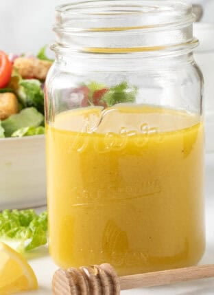 Honey Vinaigrette in a clear glass mason jar.