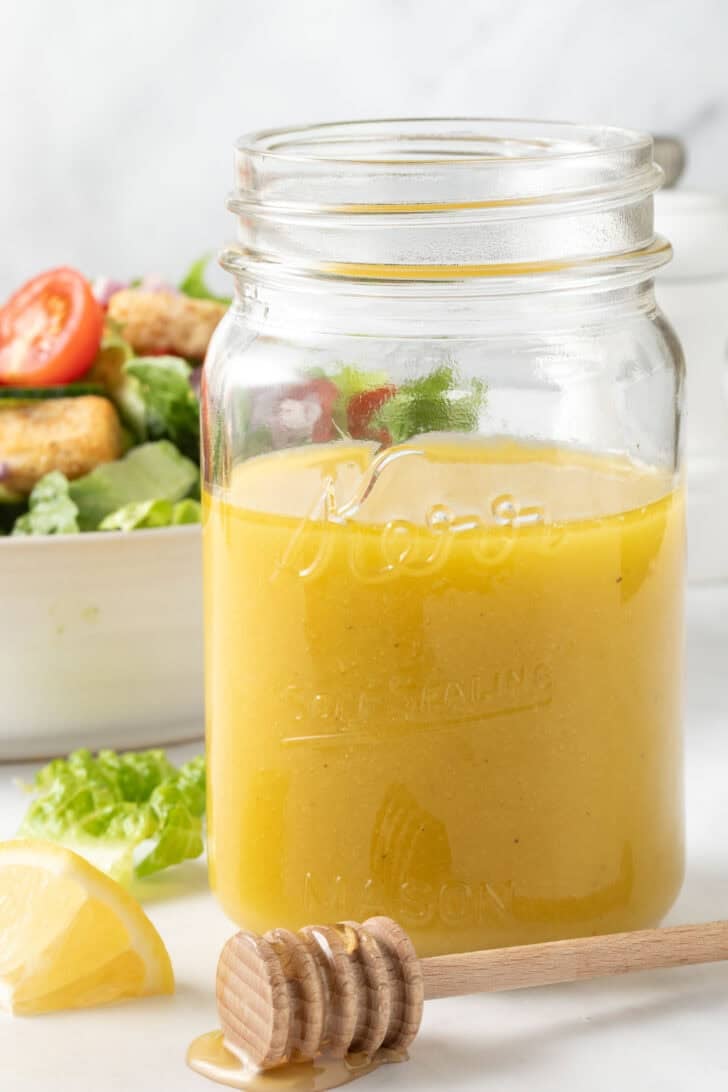 Honey Vinaigrette Homemade Honey Vinaigrette in a clear glass mason jar.