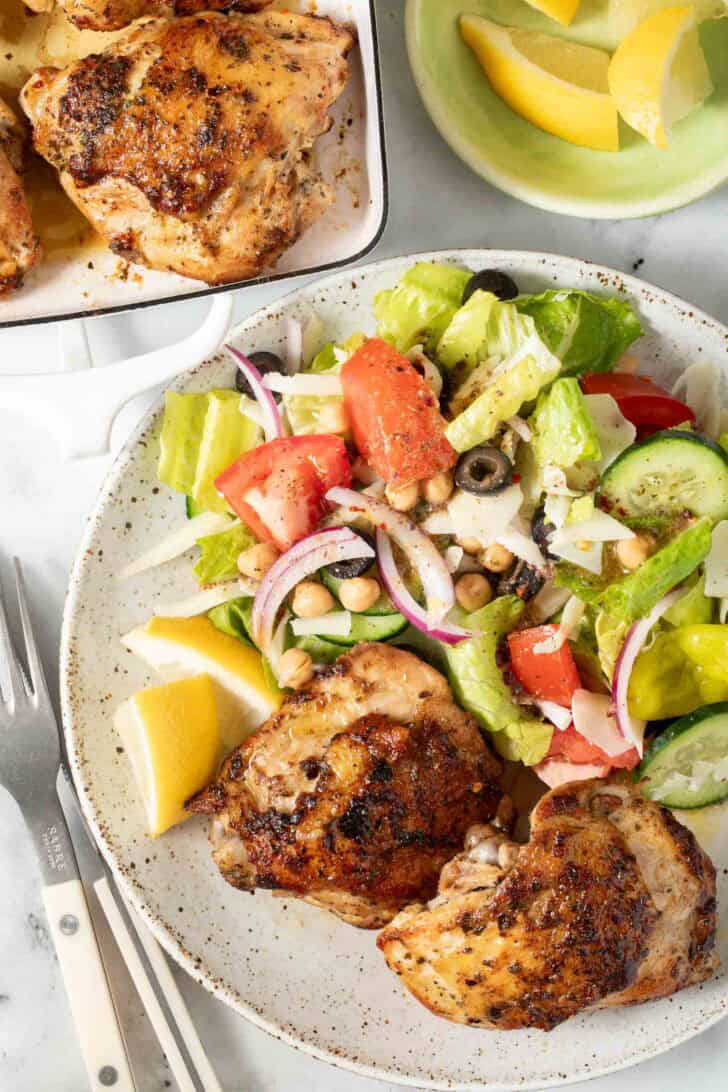 Baked Italian Chicken Thighs Baked Italian Chicken Thighs on a white plate.