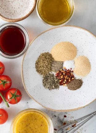 Homemade Italian Dressing Mix spices in a small white dish.