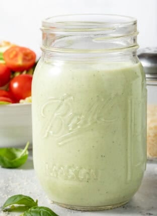 Pesto Ranch Dressing in a clear glass mason jar.