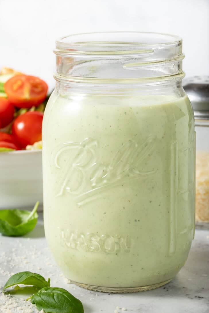 Pesto Ranch Dressing in a clear glass mason jar.