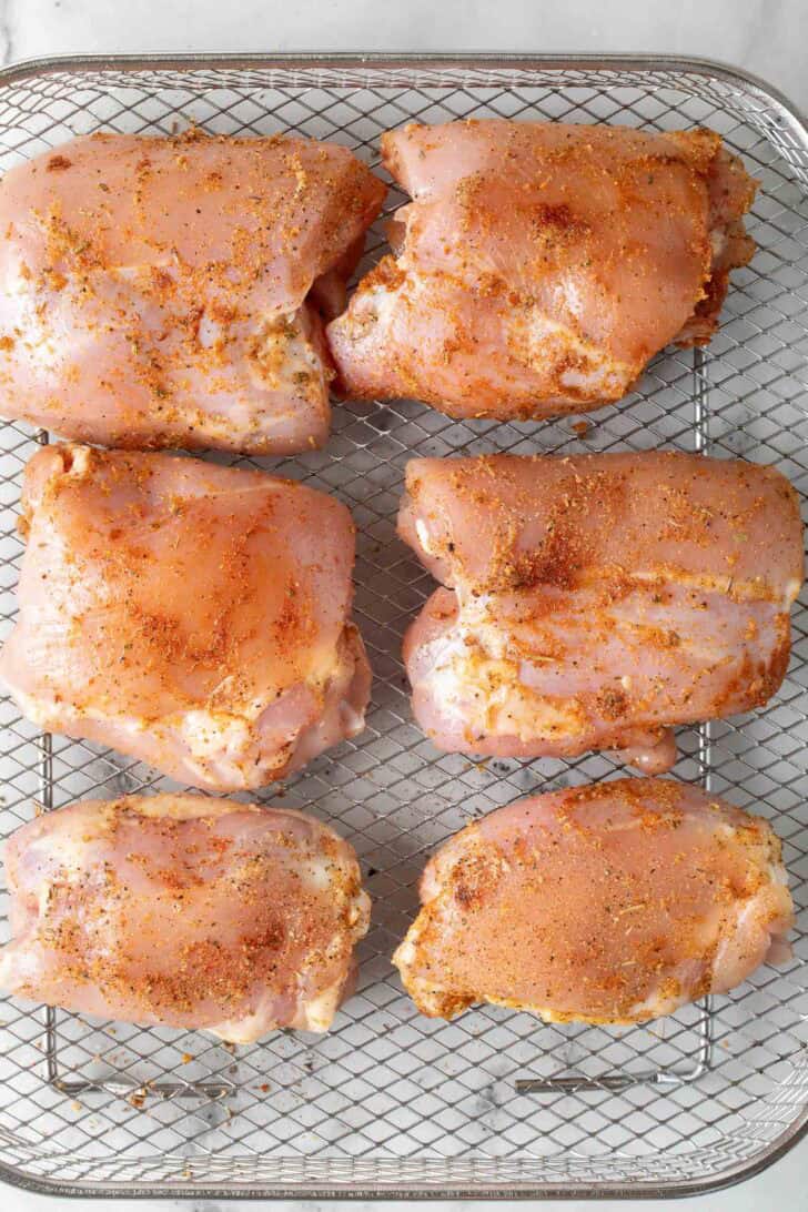 Boneless Chicken Thighs In Air Fryer Seasoned boneless skinless chicken thighs in air fryer basket for air fryer chicken.