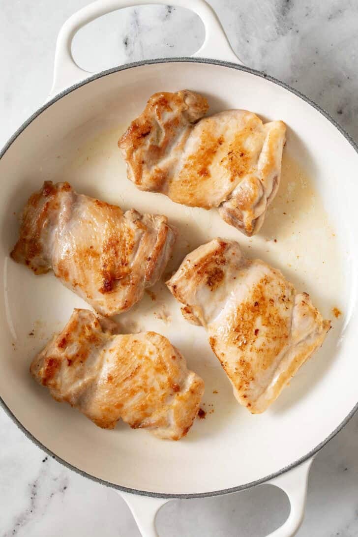 Pan Seared Boursin Chicken in a white skillet.