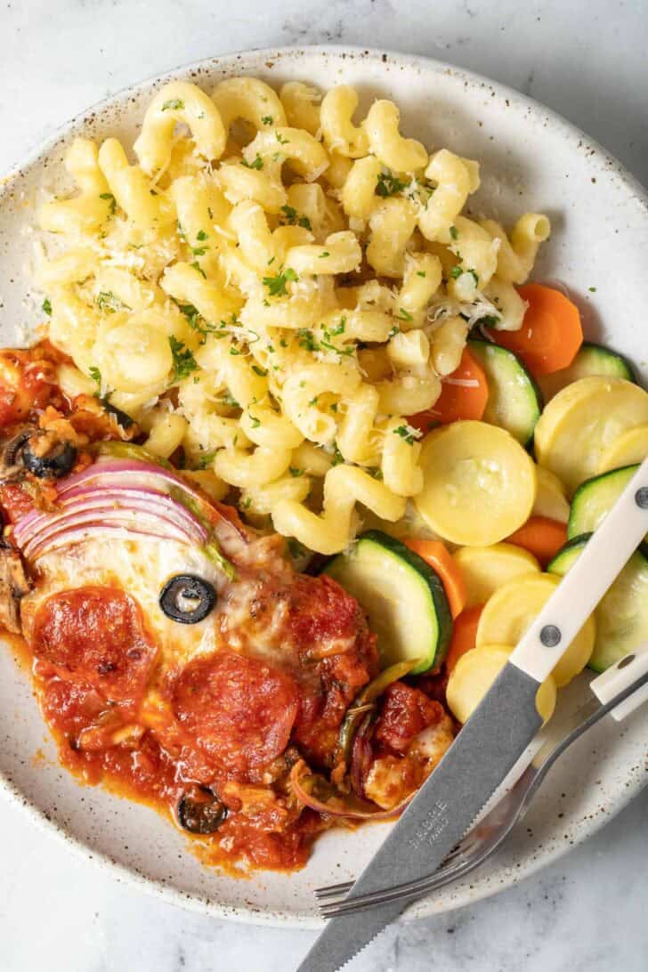 Chicken Breast Pizza Chicken Breast Pizza on a plate with vegetables and pasta.