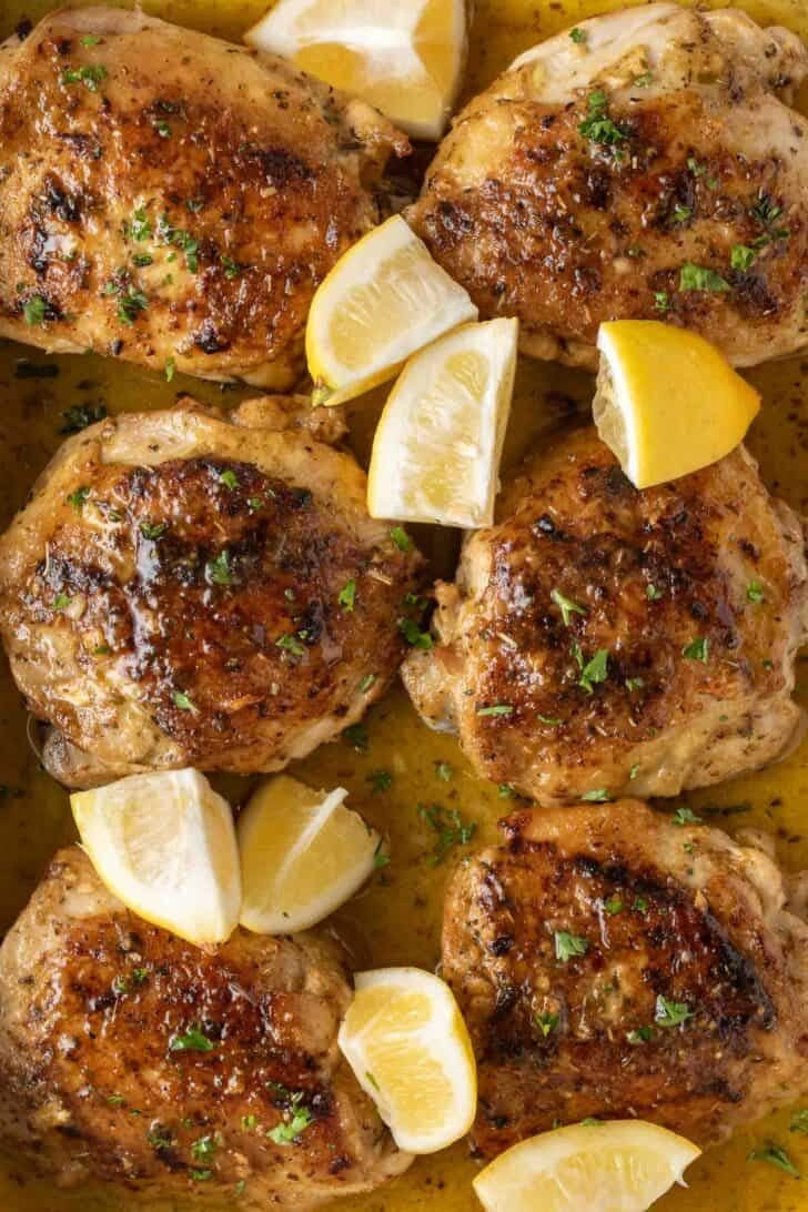Greek Lemon Chicken Greek Lemon Chicken Thighs in a roasting pan.