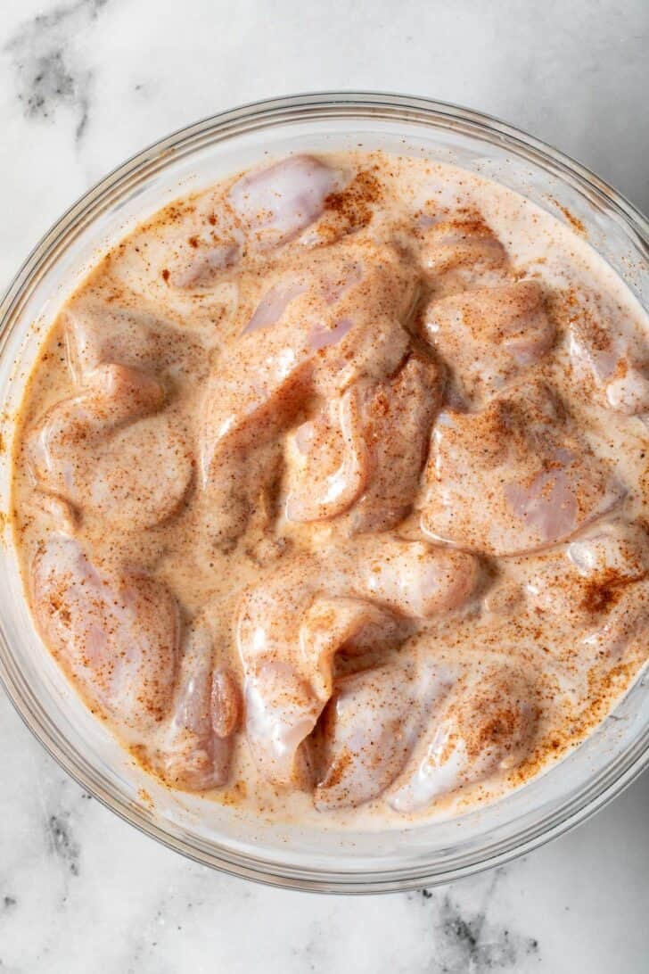 How to Make Fried Chicken Tacos Seasoned chicken thighs dredging in buttermilk for fried chicken tacos.