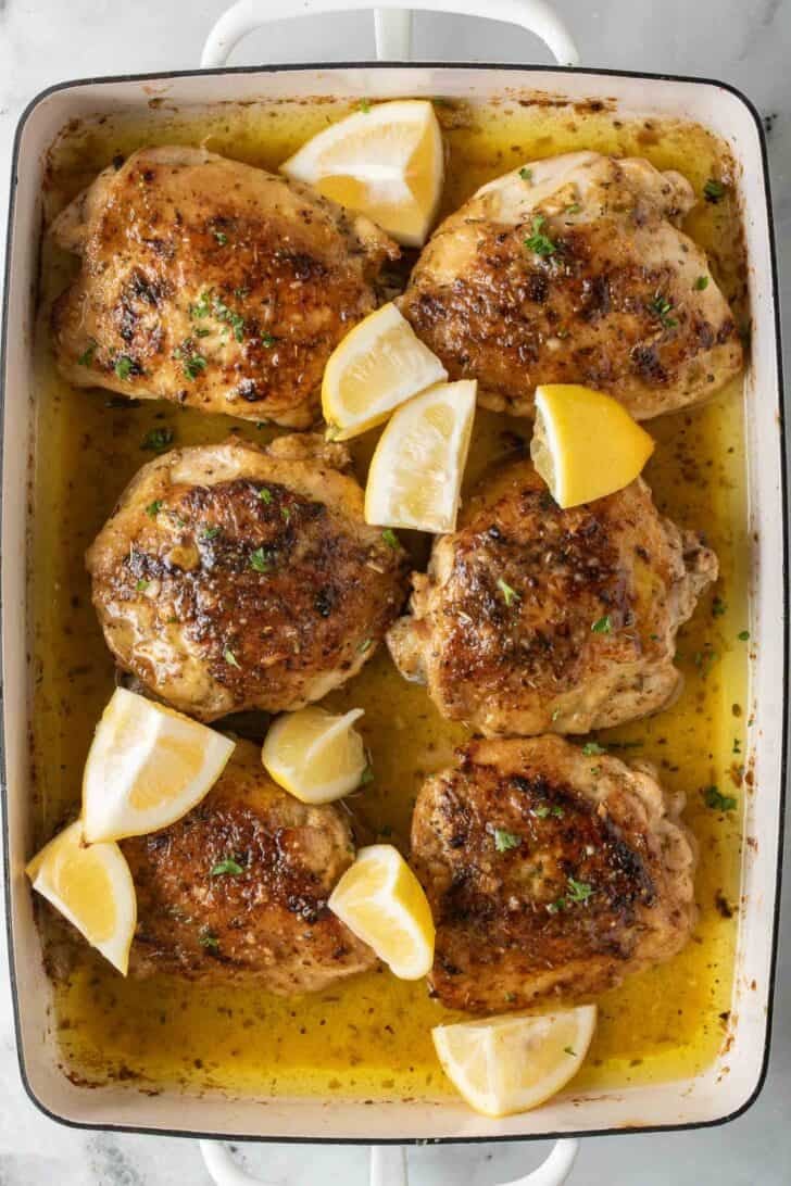 Lemon Greek Chicken Lemon Greek Chicken in a white roasting pan.