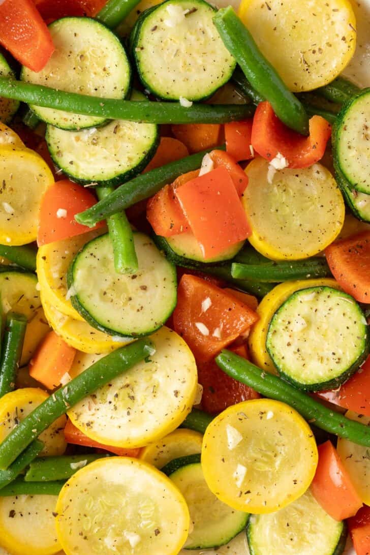 How to Make Sautéed Vegetables Sautéed vegetable medley in a white skillet.