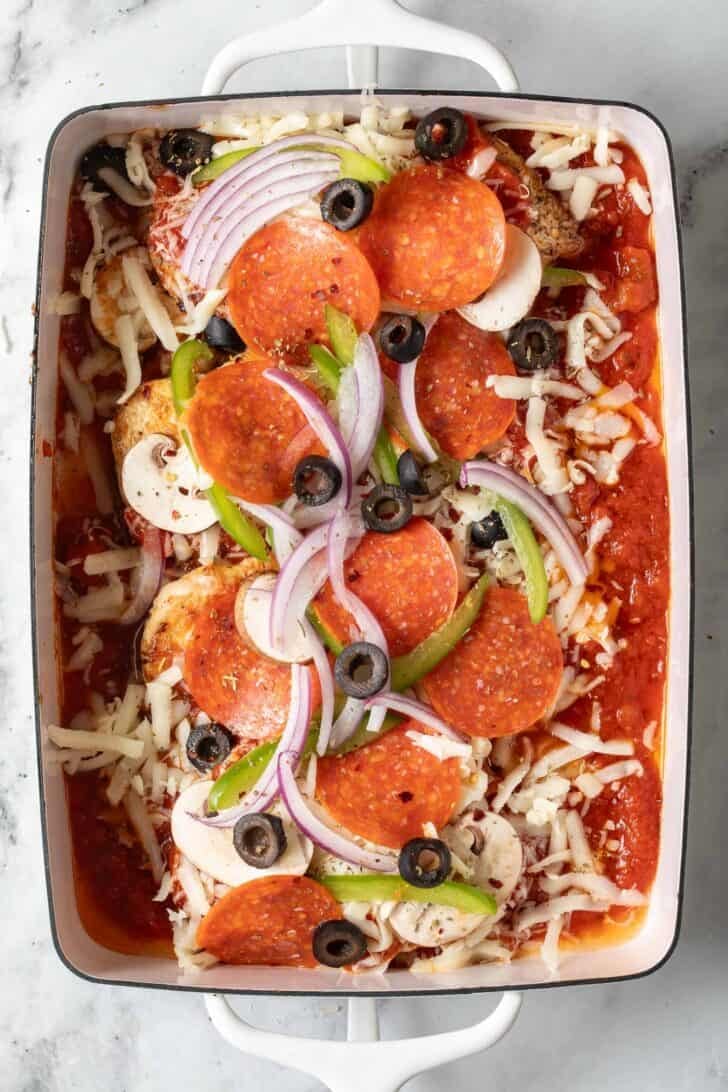 Chicken and Pepperoni Pizza Bake Chicken and Pepperoni Bake in a white baking dish.