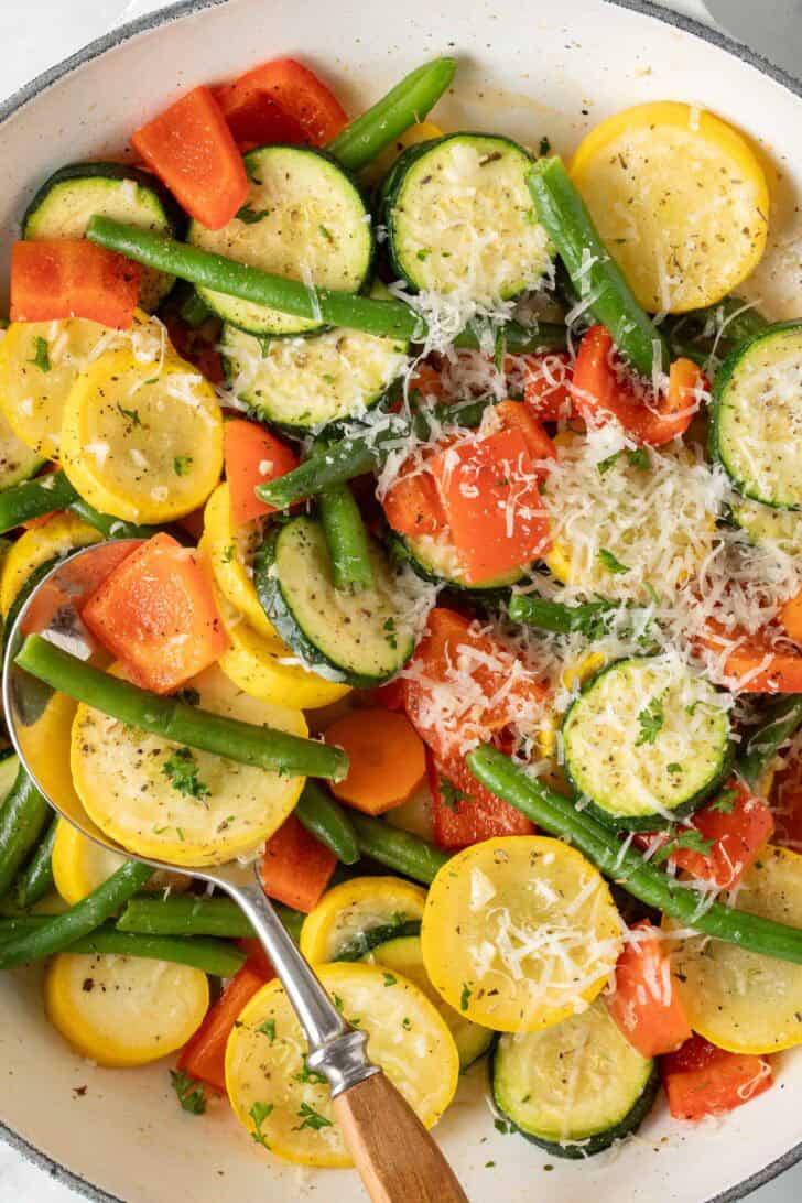 Sautéed Vegetables Sautéed vegetables in a white skillet.