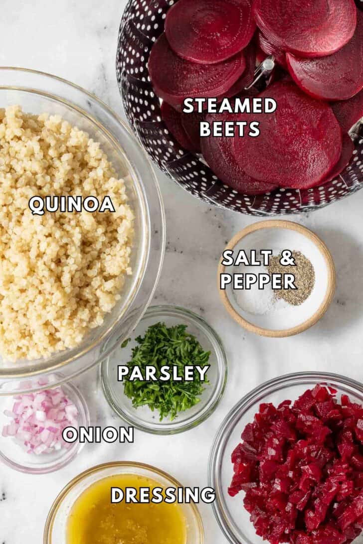 Beet Quinoa Recipe Clear glass bowls filled with diced steamed beets, cooked quinoa, minced red onion and salad dressing for a beet quinoa recipe.
