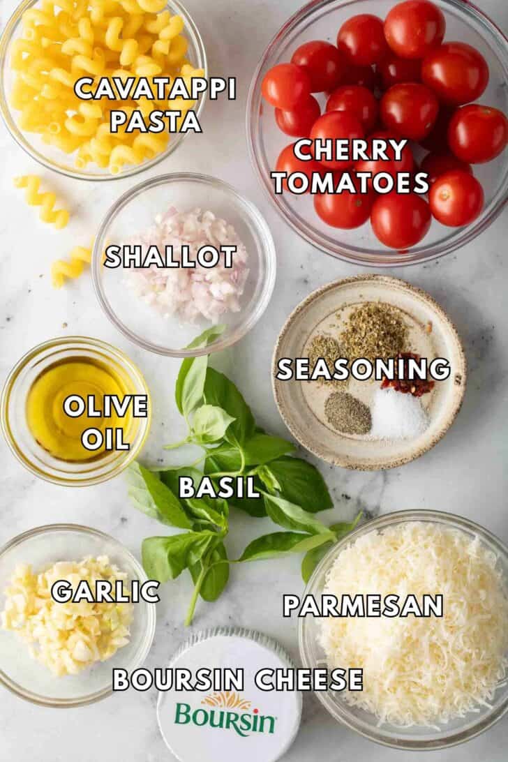 Boursin Pasta Recipe Clear glass bowls filled with pasta, cherry tomatoes, parmesan cheese and Boursin cheese.