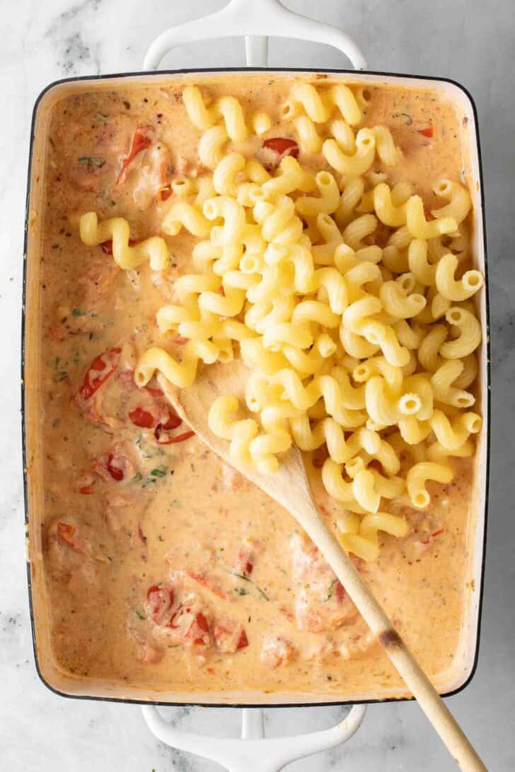 Boursin Pasta Recipe Boursin Cheese melted with cherry tomatoes and pasta in a baking dish.