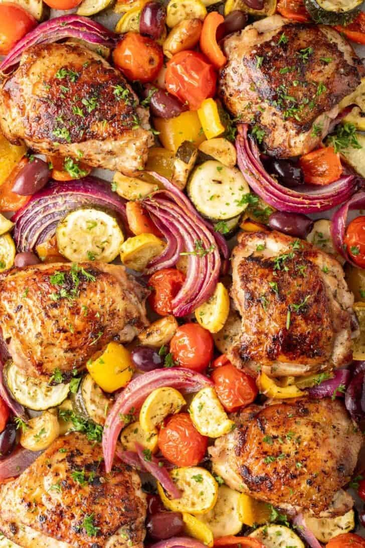 Greek Sheet Pan Chicken Greek Sheet and vegetables on a sheet pan.