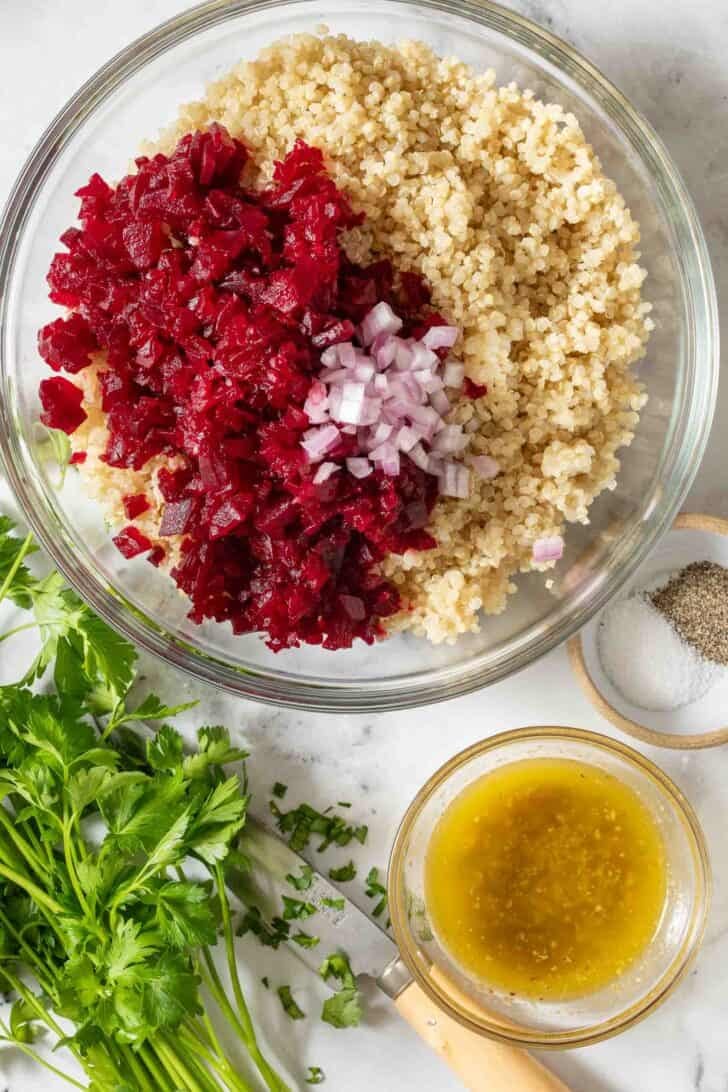 Beets and Quinoa Clear glass bowl filled with steamed beets and quinoa.