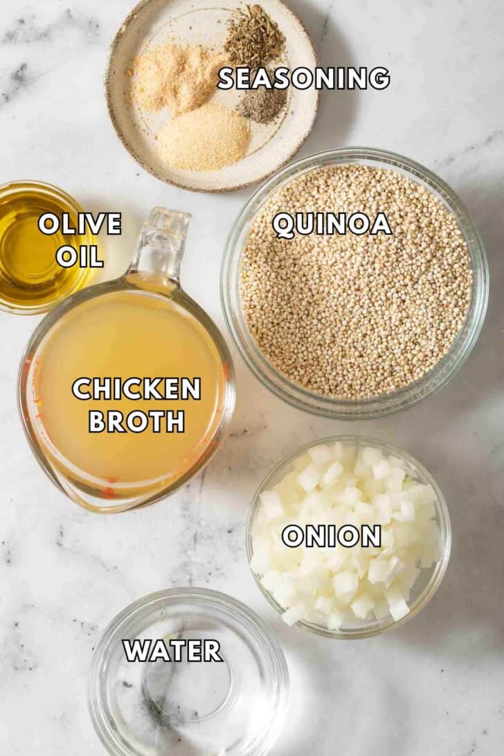 How to Make Quinoa Flavorful Small glass bowls filled with dry quinoa, chicken broth, seasoning and onion for flavored quinoa.