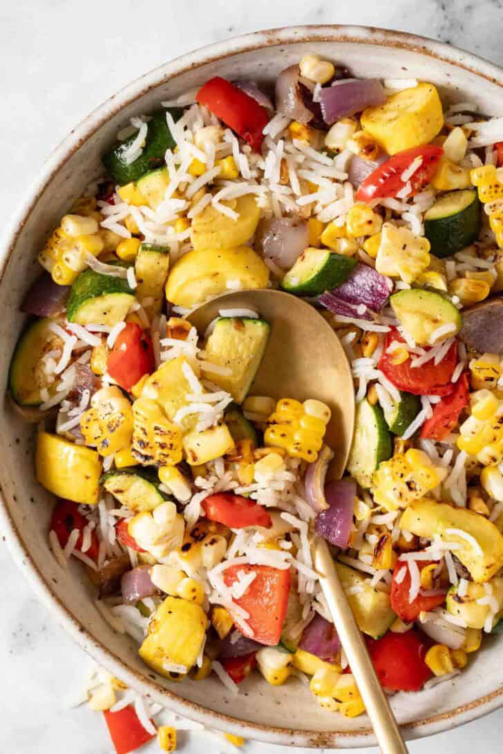 Rice with Vegetables Basmati Rice with Vegetables in a bowl with a serving spoon.