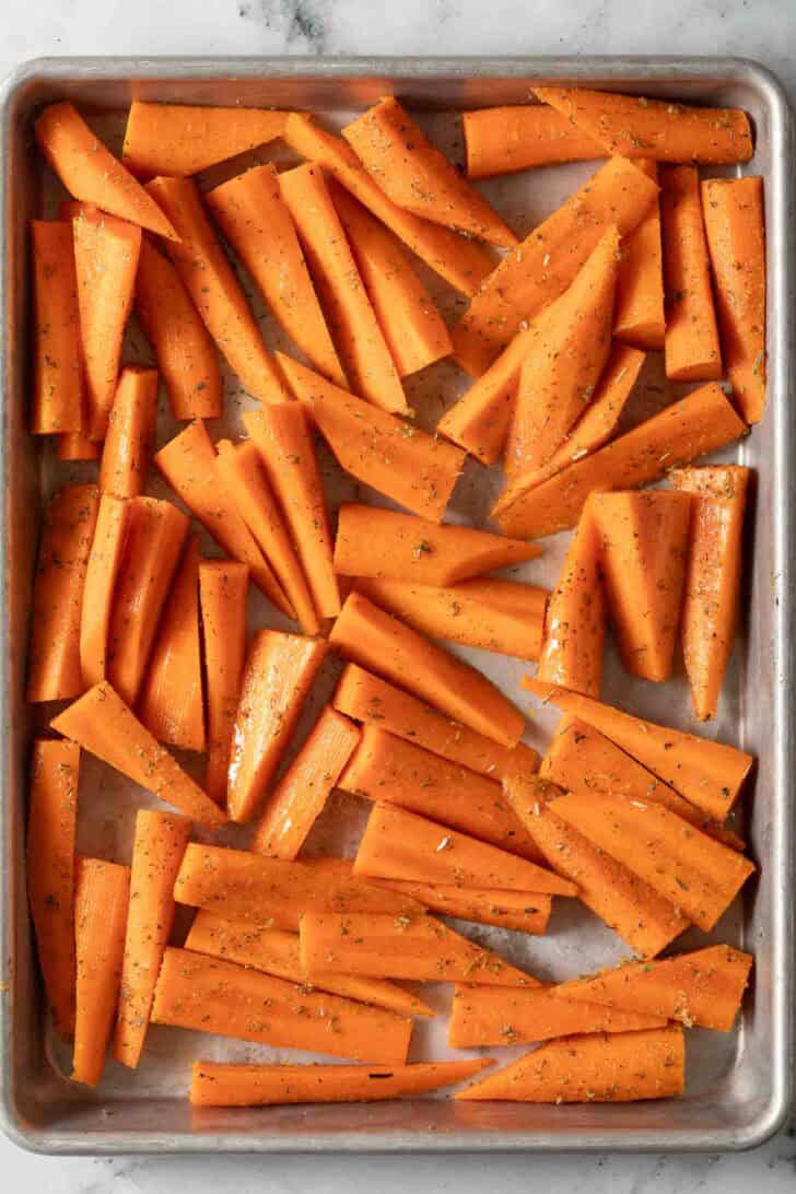 How to Roast Carrots In Oven Cut Carrots on a baking tray.
