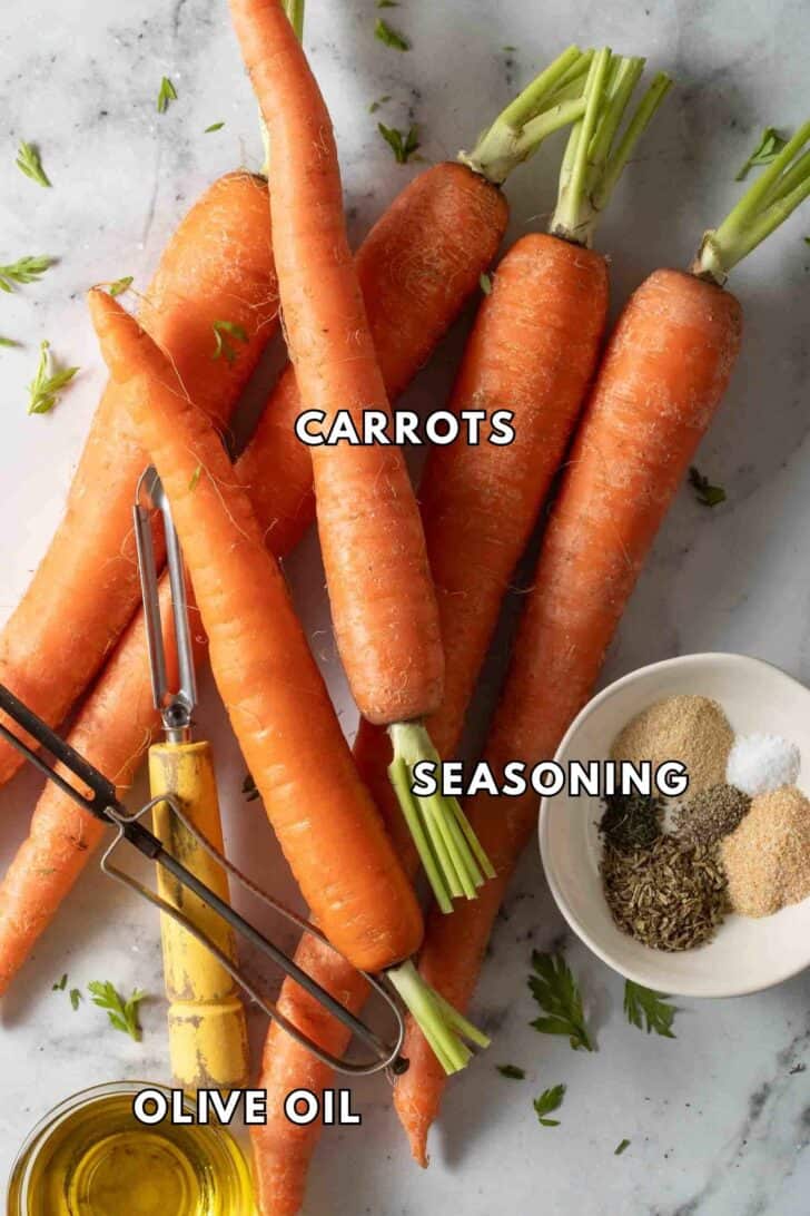 Oven Roasted Carrots Recipe Raw carrots with a dish of olive oil and seasoning for oven roasted carrots.