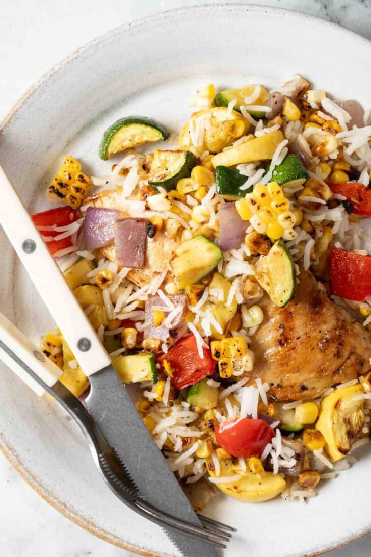 Making Vegetable Rice Vegetable Rice with grilled chicken on a plate.