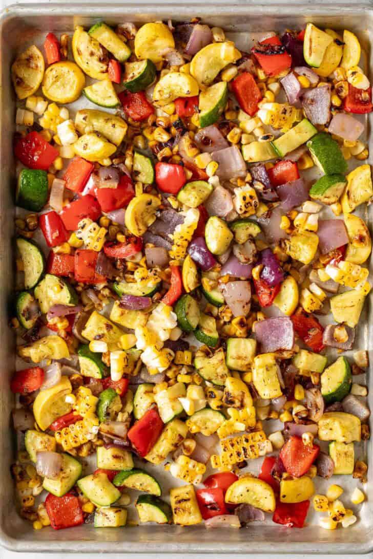 Summer Roasted Vegetables Summer Roasted Vegetables with zucchini, yellow squash, onion and corn on a sheet pan.