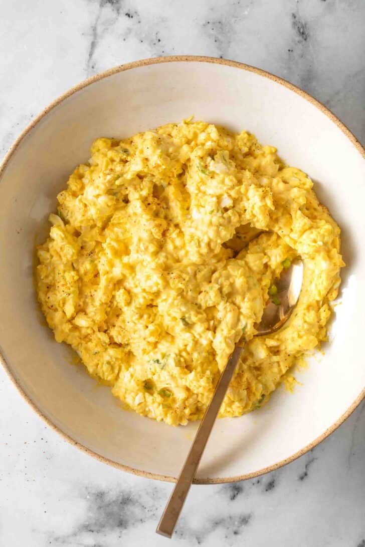 Simple Egg Salad Recipe Simple Egg Salad in a bowl with a spoon.