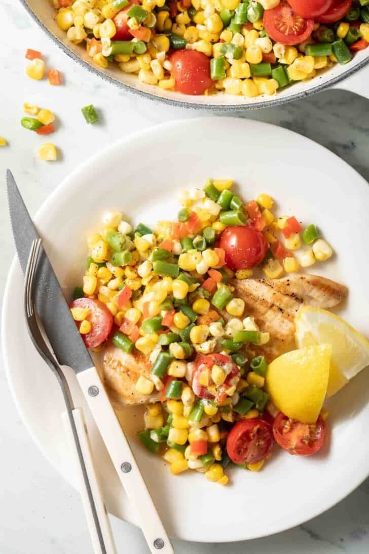 How to Make Succotash Succotash on a plate with grilled chicken.