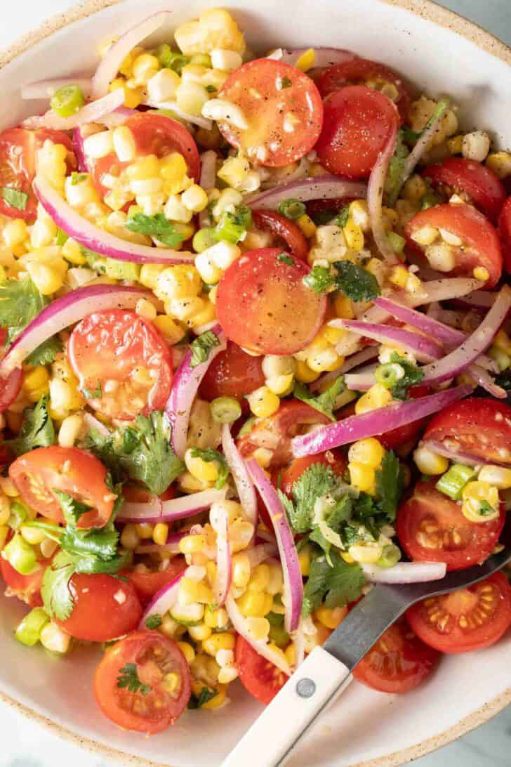 Corn Tomato Salad Corn Tomato Salad in a white bowl.