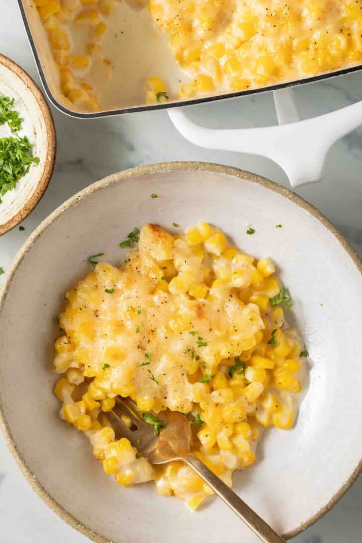 Cream Style Corn Recipe Cream Style Corn in a bowl with a fork.