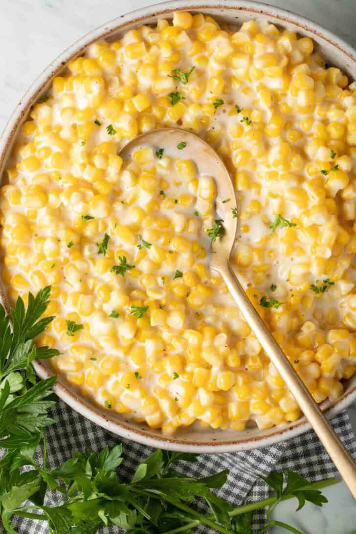 Creamed Corn Creamed Corn in a bowl with a serving spoon.