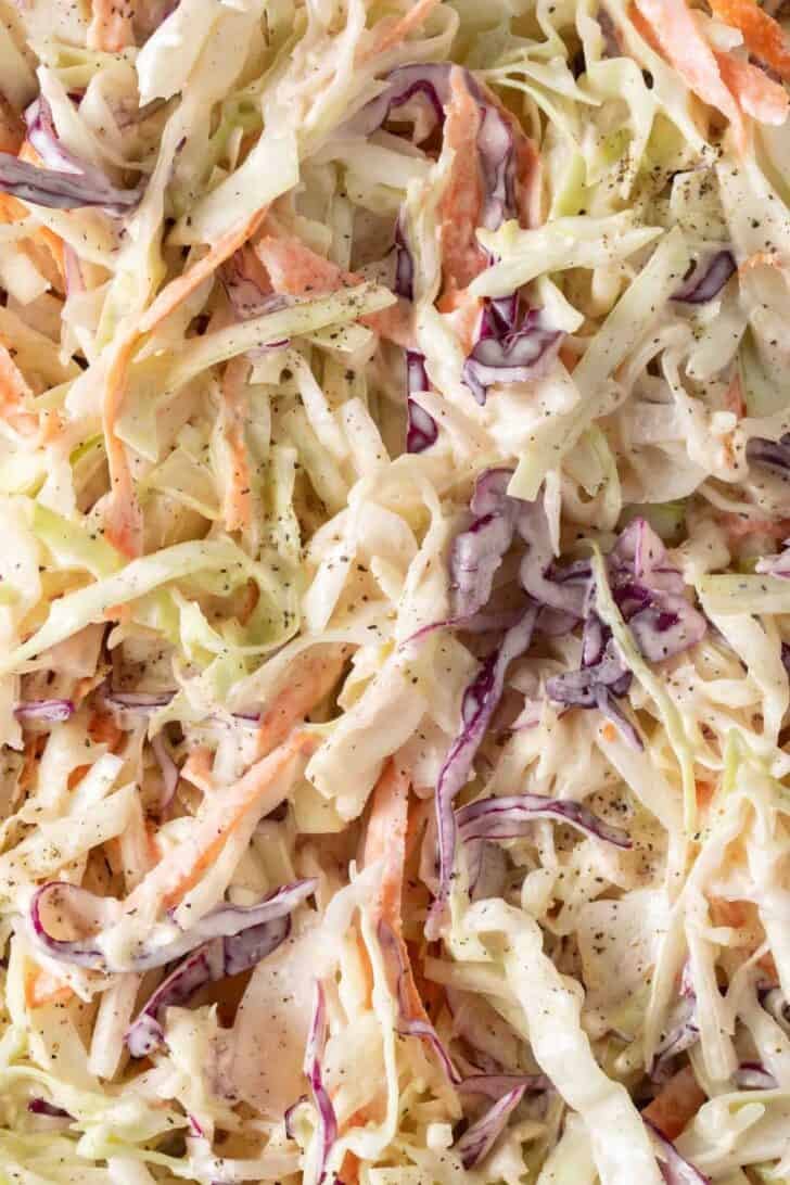 Quick Coleslaw Recipe Homemade coleslaw in a white bowl.
