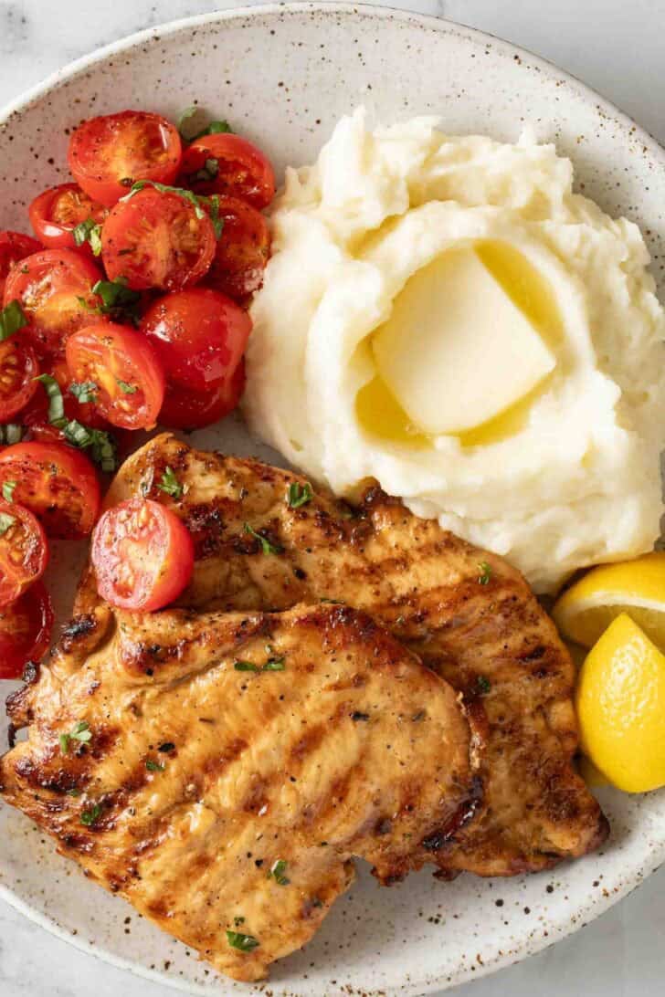 Grilled Lemon Garlic Chicken Grilled Lemon Garlic Chicken on a plate with mashed potatoes.