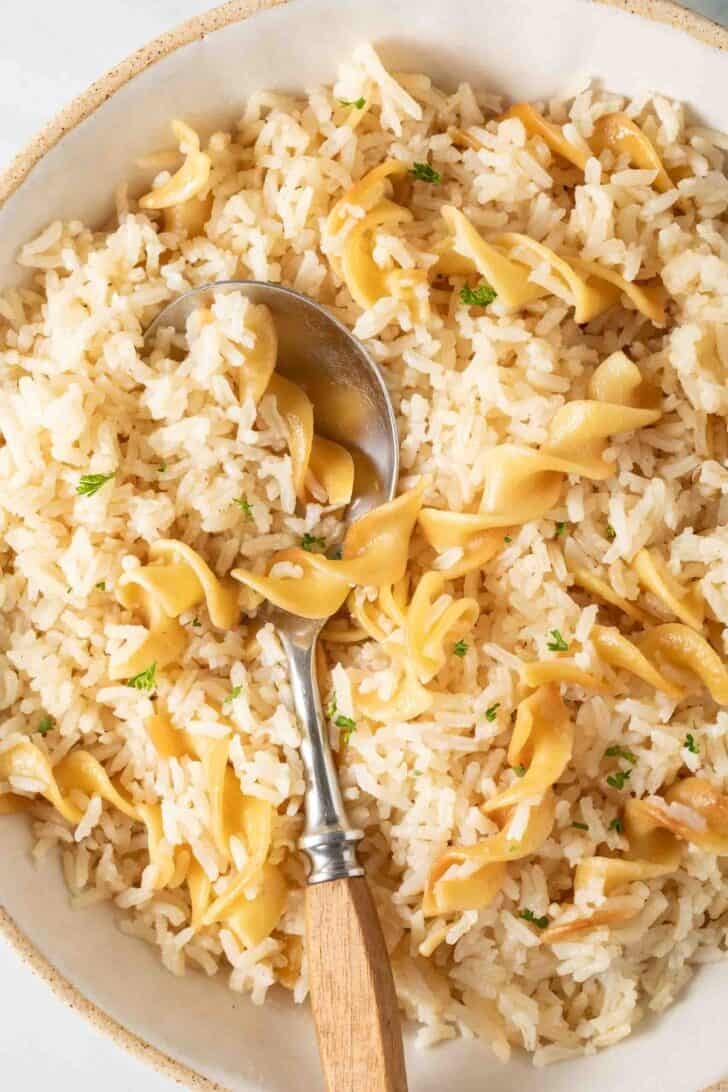 Easy Rice Pilaf Rice Pilaf in a bowl with a spoon.