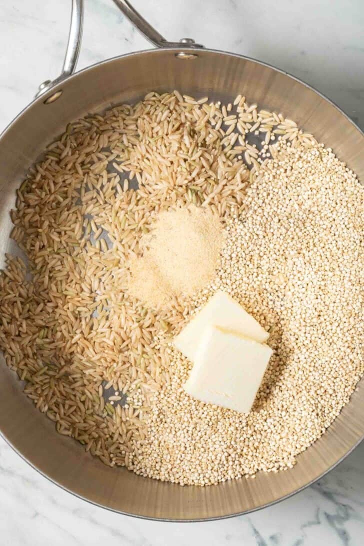 How to Cook Quinoa Rice Uncooked quinoa and brown rice in a skillet.