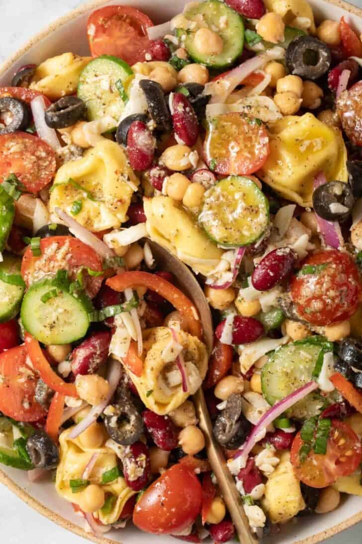 Tortellini Salad Tortellini Salad in a bowl with a serving spoon.